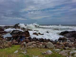 Wall Mural - waves crashing against the rocks on the beach in Florianópolis