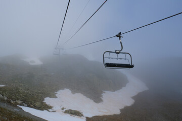 Sticker - Empty ski lift seats in the fog at L'Index,  Aiguille Rouges , La Flegere, Chamonix, French Alps, Rhone Alpes, France. 