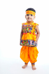 indian little boy Displaying Traditional Indian Costumes Worn During the Hindu Festival of Navratri in the state of Gujarat, India , Isolated, White