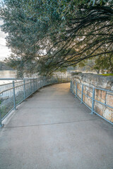 Canvas Print - Paved pathway in Austin Texas along a river and under a canopy of trees