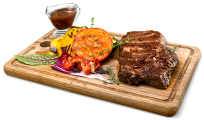 Wall Mural - a big grilled steak on a wooden plate, top view