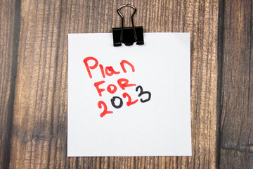 PLAN FOR 2023 text on paper with a stationery clip. Planning in 2023.