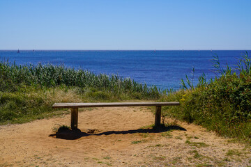 Canvas Print - wooden bench empty beach in atlantic coast sea in vendee France Les Sables-d'Olonne