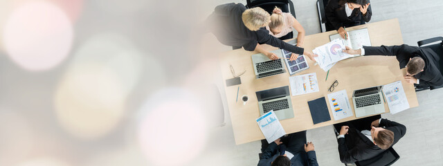 Business people group meeting shot from top widen view in office . Profession businesswomen, businessmen and office workers working in team conference with project planning document on meeting table .