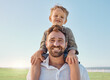 © Beaunitta V W/peopleimages.com - Family, father and child with smile at nature park for fun, relax and freedom with a blue sky. Portrait of happy man and playful boy kid outdoor for love, piggyback and bonding on a summer vacation