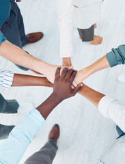 Wall Mural - Diversity, partnership collaboration and hands of business people stack in community support, trust and solidarity. Mission teamwork, team building meeting and businessman and women together top view