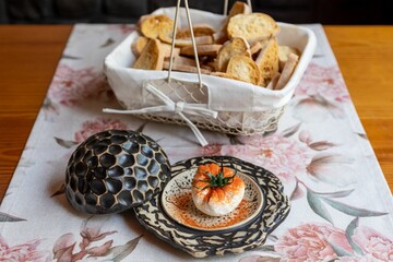 Canvas Print - Breakfast table with Burrata cheese and sliced bread on creative plates