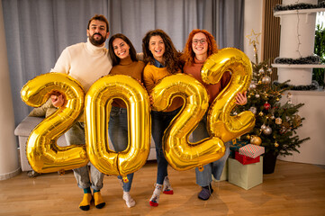 Wall Mural - Group of young beautiful people in casual clothing carrying gold colored numbers and smiling