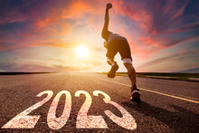 Young Man Running And Sprinting On The Road With New Year 2023 Concept