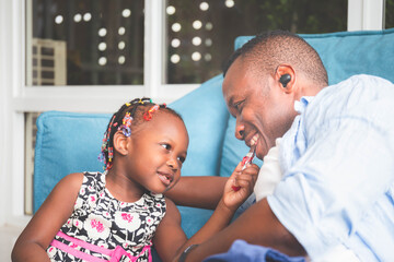 Wall Mural - Cheerful father and daughter playing in the living room, Happiness family and Father's day concepts