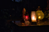 Fototapeta  - candles on the cemetery on the grave at night, all Saints Day