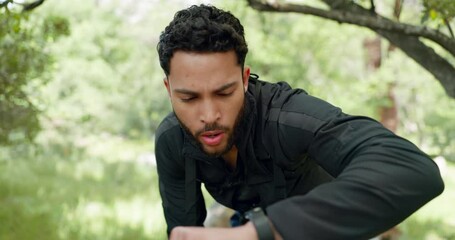 Canvas Print - Time, tired and running with a sports man checking his watch during fitness, exercise or a cardio workout. Health, training and sport with a male runner or athlete in the forest for an endurance run