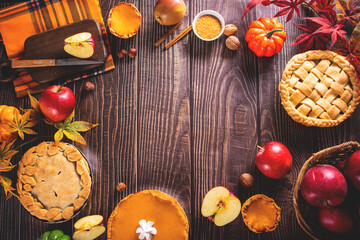 Pieces of traditional american homemade autumn apple and pumpkin pie for Thanksgiving day or Halloween