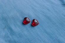 Red Plastic And Glass Hearts On Denim Background For Valentine's Day,  Love Symbol