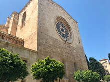 Tarragona, Spain, June 2019 - A Large Stone Building With A Clock Tower