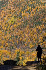 Sticker - Black silhouette of a photgrapher in front of acolored forest landscape at a view point of Riverain path in Parc des Hautes-Gorges-de-la-Malbaie