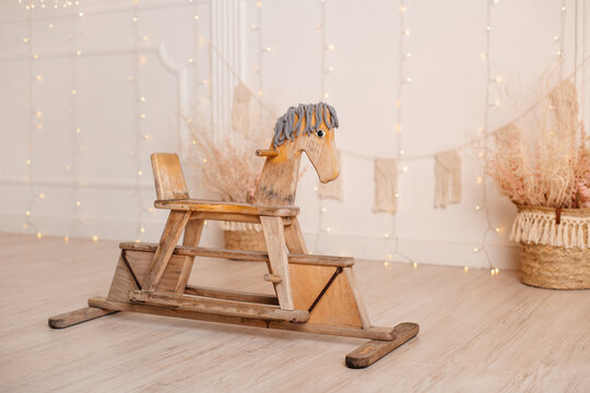 nice vintage classic wooden rocking horse chair on wooden floor shot in a blurred vintage interior b