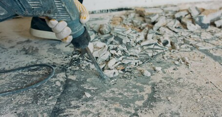 Wall Mural - Tiles to be removed with an electric percussion demolition hammer by a craftsman in work clothes, in a renovated apartment.