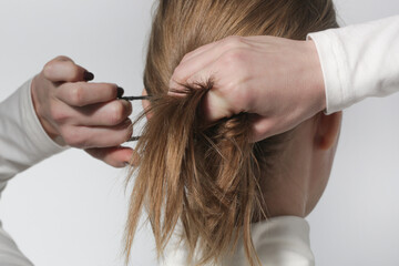 Serie of photos of making a low ponytail with basic elastic hair band. Back view of young woman tied her hair in ponytail.