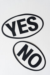 Canvas Print - yes and no encircled with oval rings or forms on white paper