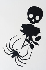 Wall Mural - black paper skull, rose, and spider on blank paper