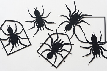 Wall Mural - black paper silhouettes of spiders and shields