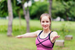 © gballgiggs - Fit young women practicing yoga at green park in the morning