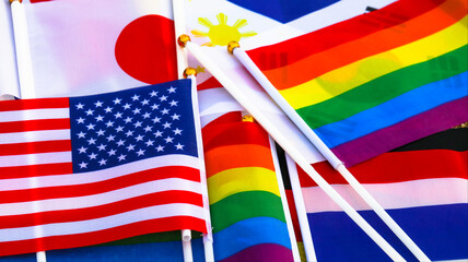 Wall Mural - LGBT rainbow flag stay together with the flag of countries background to enhance LGBTQ+ community around the world                              