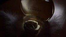 Wedding Rings Lie On A Leather Sofa Near A Bottle Of Perfume. Caption: Terre De Lumiere LEau LOccitane