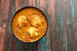 Egg roast curry or Mutta roast gravy popular side dish for appam puttu. Spicy Kerala food on dark wooden background Tamil Nadu South 