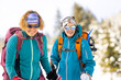 © zhukovvvlad - Portrait of two attractive young women tourists outdoors in winter.