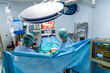 Group of surgeons doing surgery in hospital operating theater operating room
