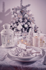 Sticker - Festive  Christmas table place setting with silverware, candles and decorated Christmas tree