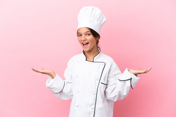 Canvas Print - Little caucasian chef girl isolated on pink background with shocked facial expression