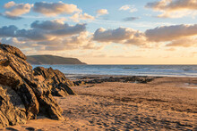 Stunning Summer Sunset Landscape Image Of Widemouth Bay In Devon England With Golden Hour Light On Beach