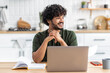 © kucherav - Distance learning. Portrait of smiling young Asian male freelancer or student sitting at home using laptop computer for online education