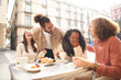 © CarlosBarquero - People group talking at coffee bar terrace. Friends having fun together at cafeteria on brunch time. Lifestyle concept with happy men and women at cafe venue. High quality photo