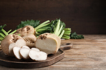Wall Mural - Cut sugar beets on wooden table. Space for text