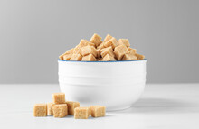 Bowl With Brown Sugar Cubes On White Table
