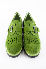 Sticker - Female green leather shoes pares on white background, isolated product.