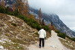 © Fotopogledi - Rear View of Senior Woman Active Recreation Hiking Uphill on Autumn Alpine Trail