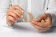 © Oleksandr - Hearing aid sound amplifier in the hands of a doctor.