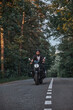 © perfectlab - Blurred Motion A young man biker in a helmet quickly rides at high speed on a forest road, in motion