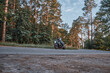 © perfectlab - Blurred Motion A young man biker in a helmet quickly rides at high speed on a forest road, in motion