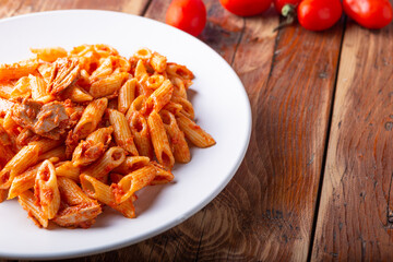 Wall Mural - Pasta with tuna in tomato sauce, typical food of Mediterranean Italian cuisine.