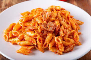 Wall Mural - Pasta with tuna in tomato sauce, typical food of Mediterranean Italian cuisine.