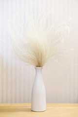 Poster - vase and flowers on a wooden table on a light background. Interior detail. Minimalism.	