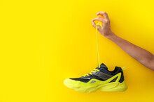 Woman Holding Modern Shoe And Showing OK Gesture On Yellow Background