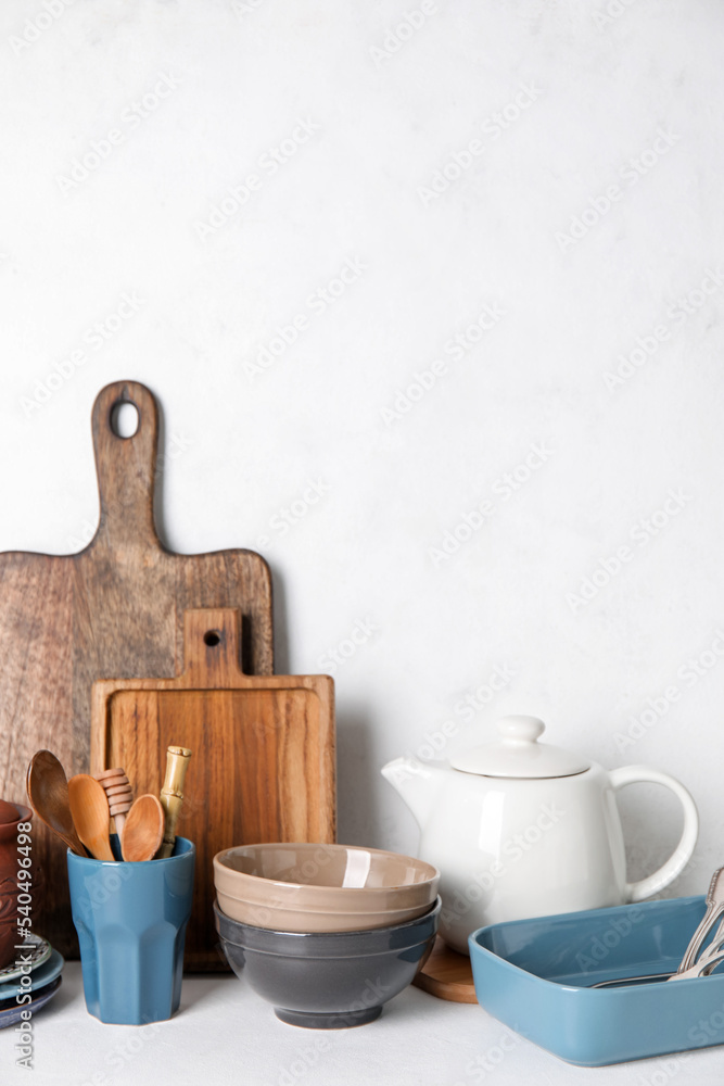 Set of different dishware and kitchenware on white table
