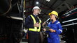 © FotoArtist - Group of apprentices with instructor at railway engineering facility. Teacher talking to apprentices at railway engineering facility